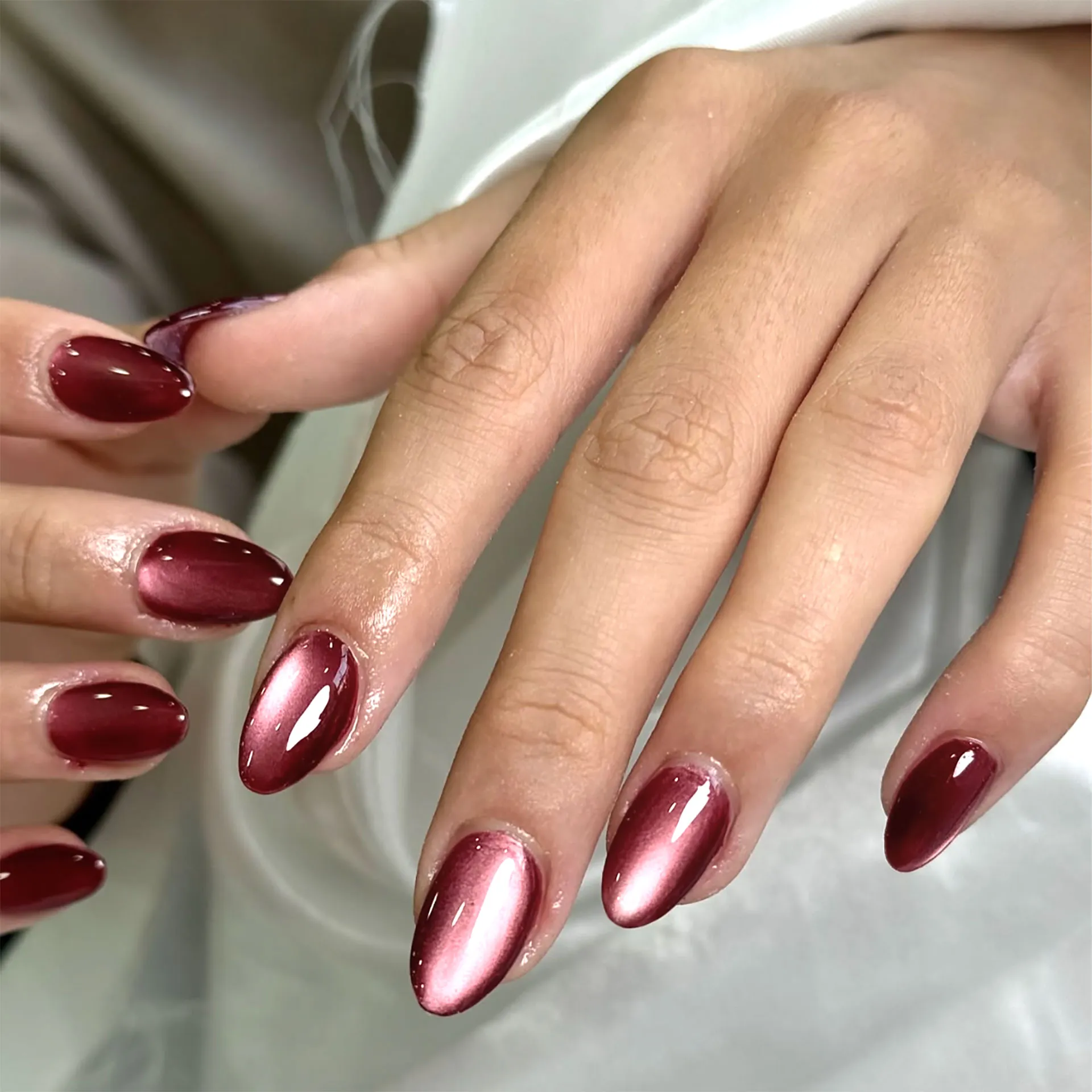 Metallic cranberry Christmas nails 2025 inspired by Kylie Jenner and Sabrina Carpenter.